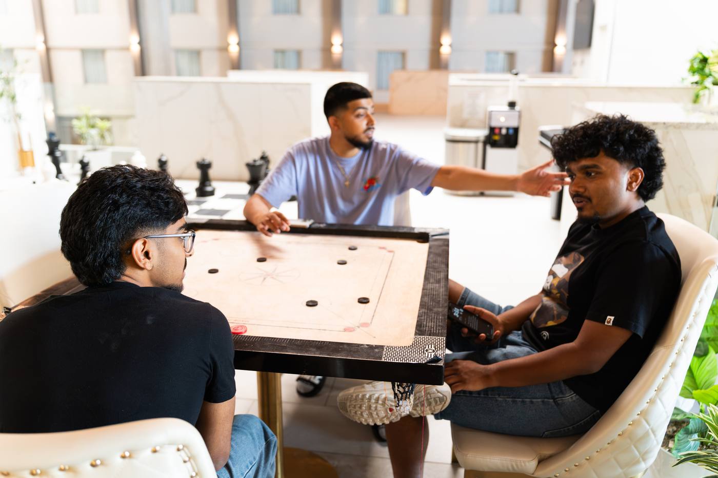 Youth playing carrom